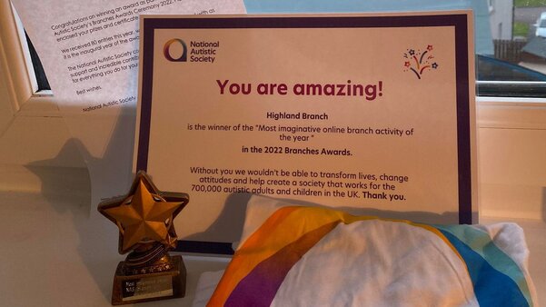 A photo of a letter, certificate, trophy and t-shirt. On the certificate are the words, 'You are amazing!'